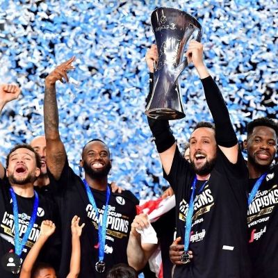 Marco Belinelli celebrating the victory with his team mates while carrying the championship trophy. 